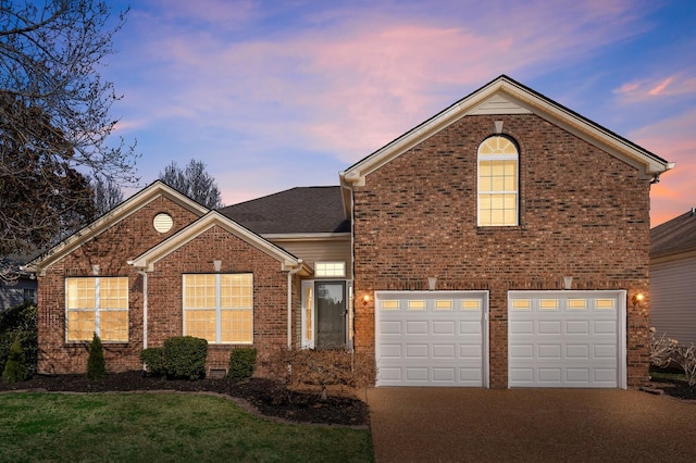 view of front of property with driveway, brick siding, and a lawn