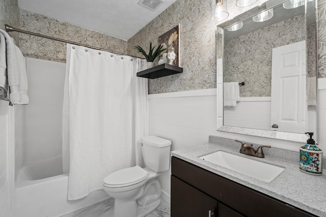 full bathroom with toilet, a wainscoted wall, vanity, visible vents, and wallpapered walls