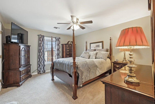 bedroom with light carpet, baseboards, visible vents, and a ceiling fan