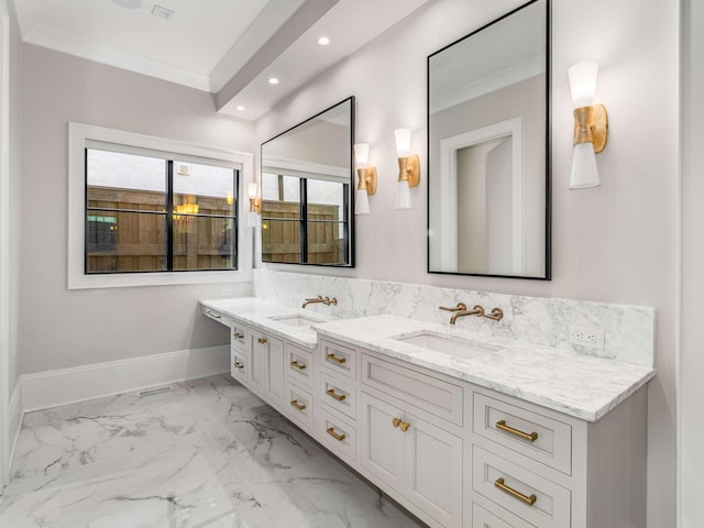 full bath with marble finish floor, crown molding, baseboards, and a sink