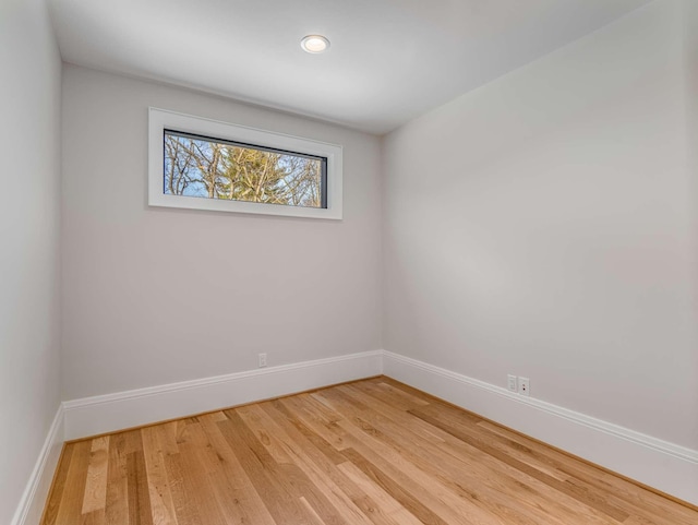 empty room featuring wood finished floors and baseboards