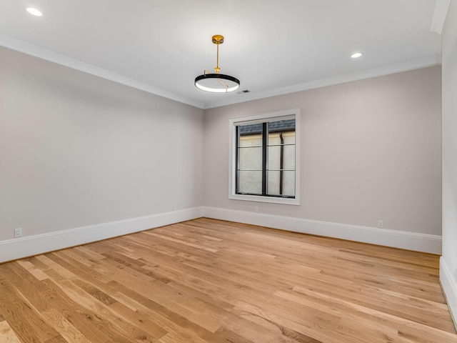 unfurnished room with light wood-style floors, baseboards, ornamental molding, and recessed lighting