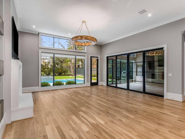 unfurnished living room featuring light wood-style flooring, recessed lighting, visible vents, baseboards, and ornamental molding