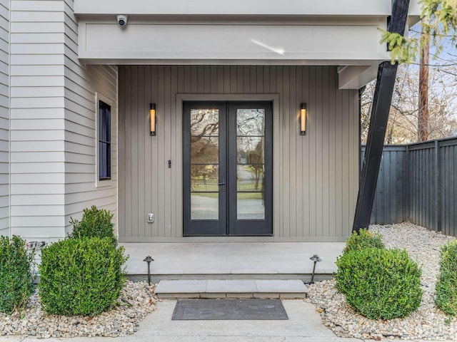 property entrance with french doors and fence