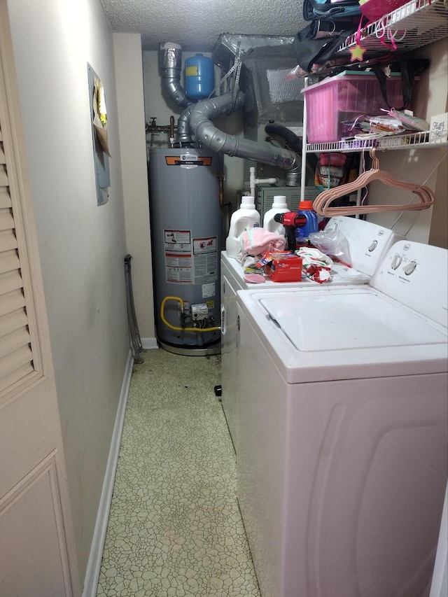 clothes washing area with laundry area, tile patterned floors, a textured ceiling, water heater, and separate washer and dryer