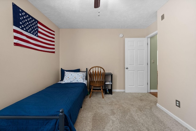 bedroom with carpet, ceiling fan, a textured ceiling, and baseboards