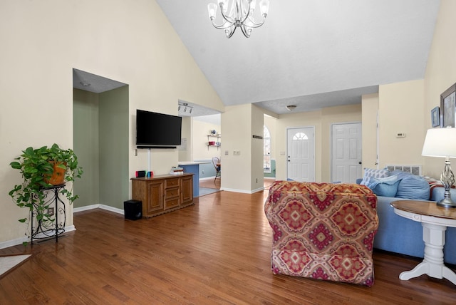 living room with baseboards, high vaulted ceiling, dark wood-style flooring, and an inviting chandelier