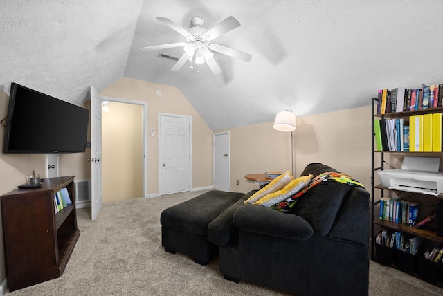 living area featuring visible vents, light colored carpet, ceiling fan, vaulted ceiling, and a textured ceiling