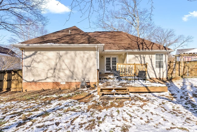 snow covered rear of property with crawl space, fence, a deck, and french doors