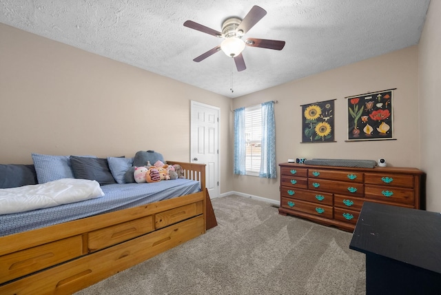 bedroom with a ceiling fan, baseboards, a textured ceiling, and light colored carpet