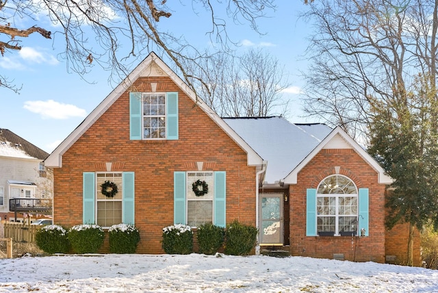 view of front facade featuring crawl space and brick siding