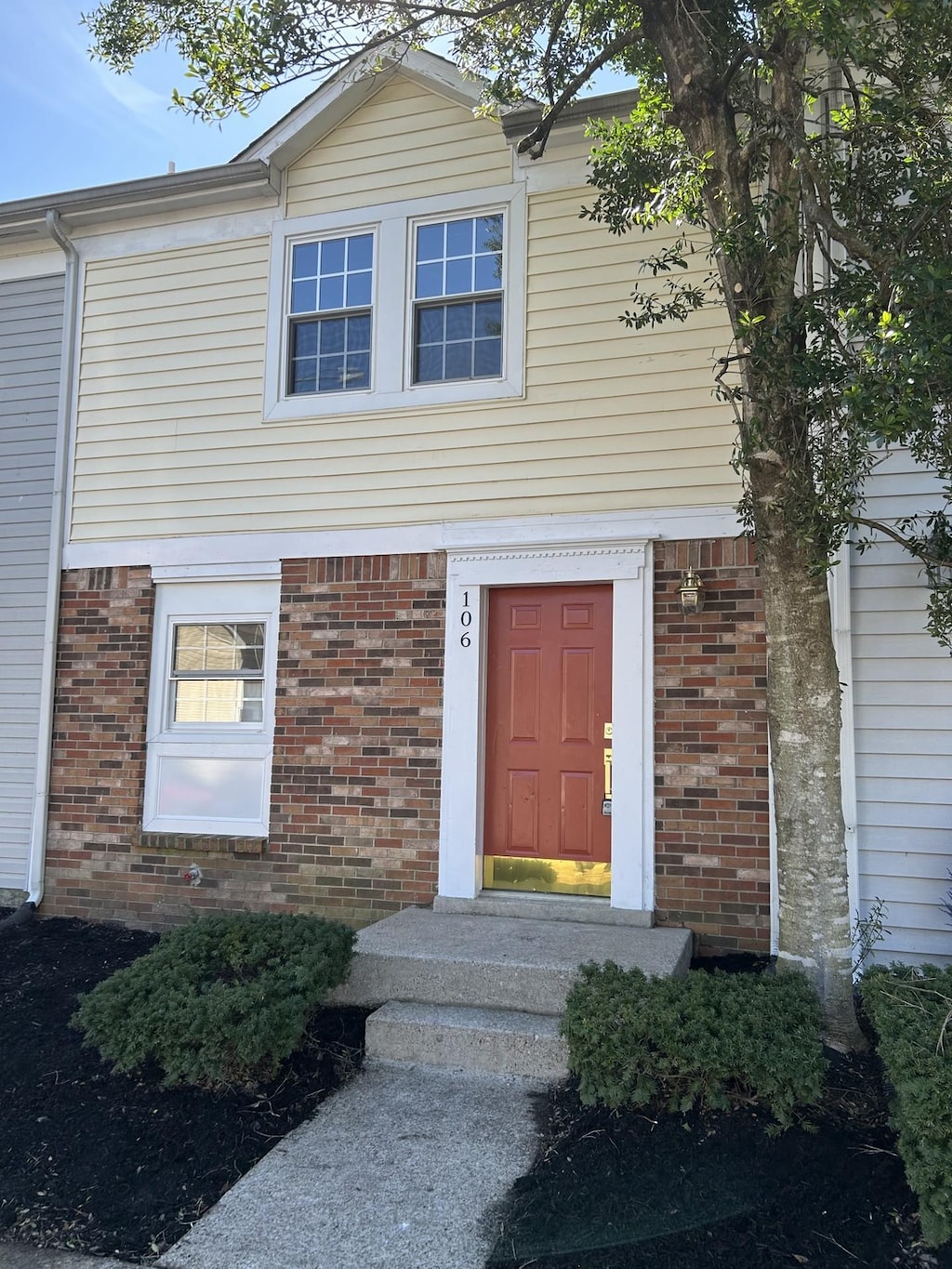 property entrance featuring brick siding