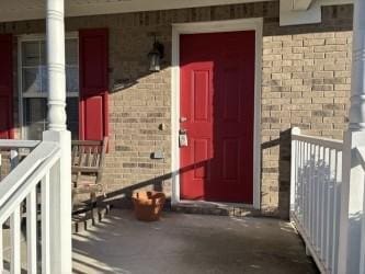 property entrance featuring brick siding