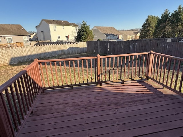 wooden deck with a fenced backyard and a residential view