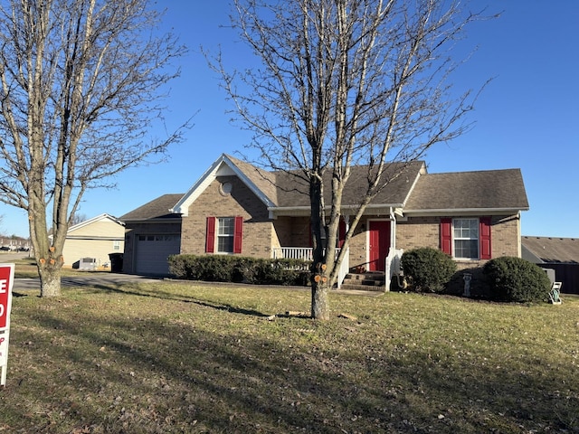 ranch-style house with brick siding, an attached garage, and a front yard