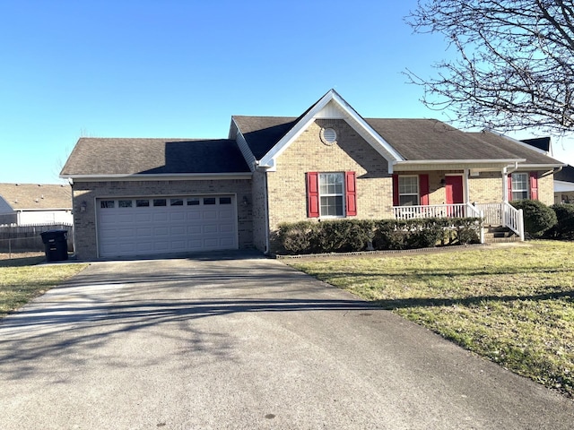 single story home featuring driveway, an attached garage, fence, a front lawn, and brick siding