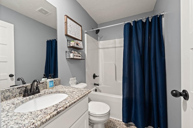 bathroom with toilet, a textured ceiling, vanity, and visible vents