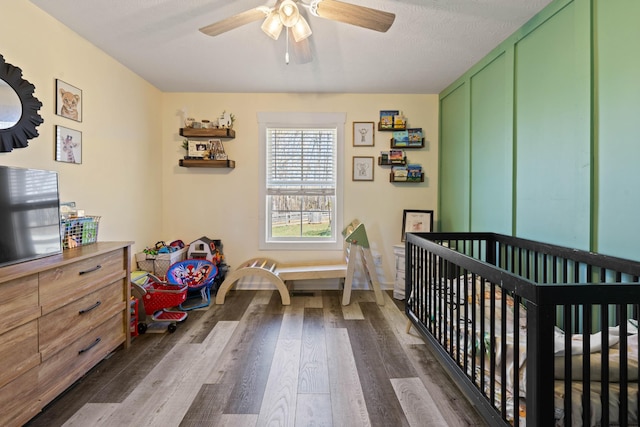 bedroom featuring dark wood-style floors and ceiling fan