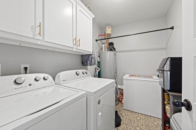 laundry room featuring a textured ceiling, water heater, washing machine and clothes dryer, and cabinet space