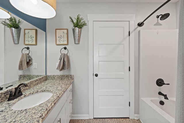 bathroom with shower / bath combination, vanity, and baseboards