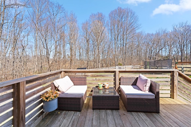 wooden deck featuring a trampoline