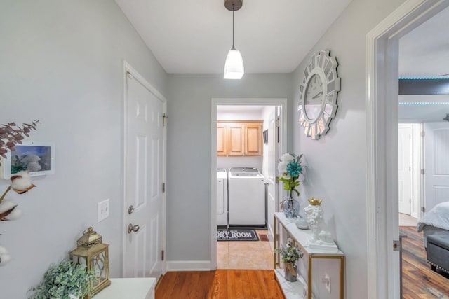 hall featuring washing machine and clothes dryer and light wood-style flooring