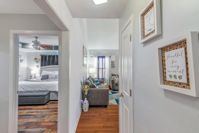 corridor featuring dark wood-style flooring