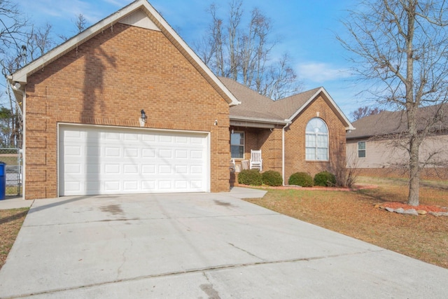 view of front facade featuring driveway, brick siding, an attached garage, and a shingled roof