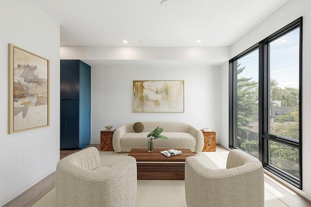 living area featuring recessed lighting and baseboards