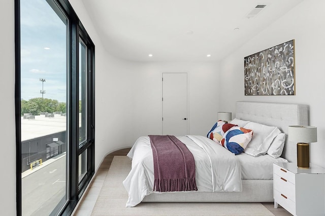 bedroom featuring light wood-type flooring, visible vents, and recessed lighting