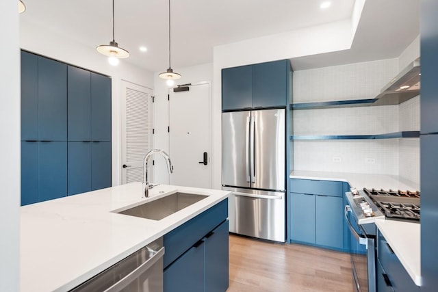 kitchen with appliances with stainless steel finishes, light countertops, blue cabinets, and open shelves