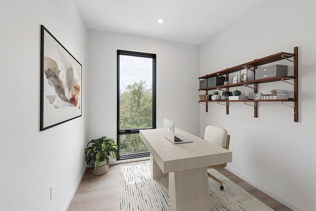 office area with light wood-style floors, recessed lighting, plenty of natural light, and baseboards