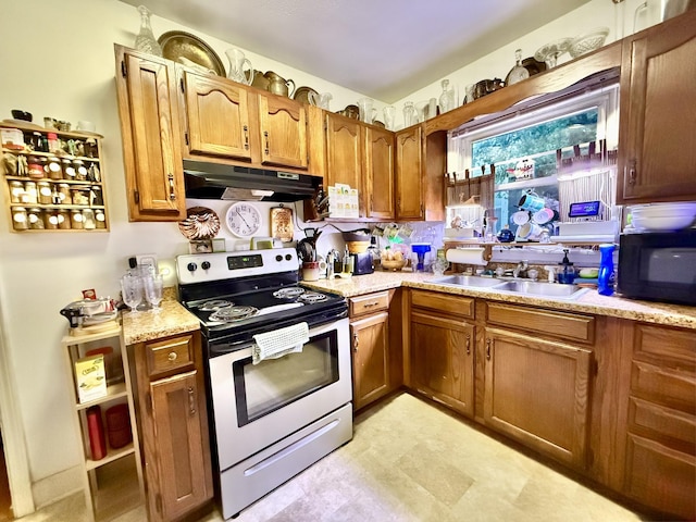 kitchen featuring black microwave, under cabinet range hood, electric range, a sink, and brown cabinetry