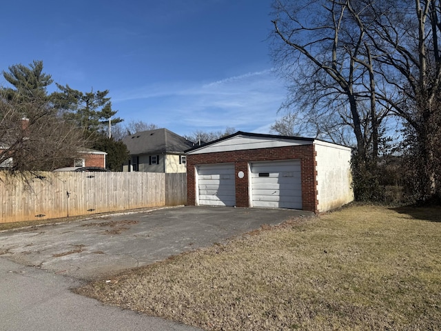 detached garage featuring fence