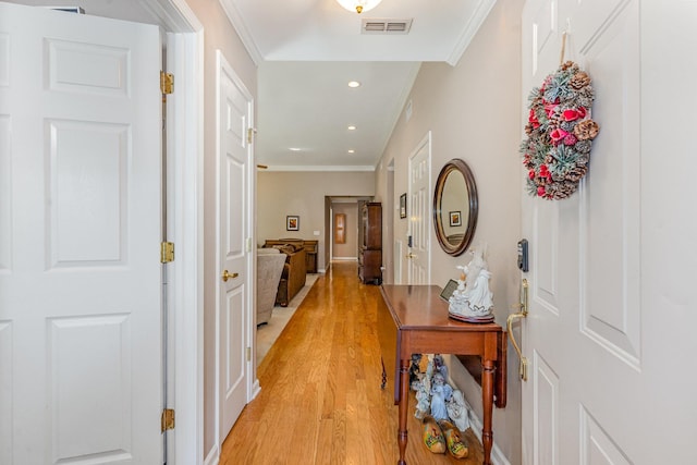 corridor with light wood-style flooring, visible vents, crown molding, and recessed lighting