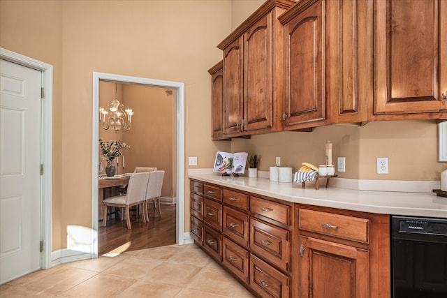 kitchen featuring brown cabinetry, light countertops, and dishwasher