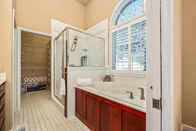 bathroom featuring visible vents, a garden tub, tile patterned flooring, vanity, and a shower stall