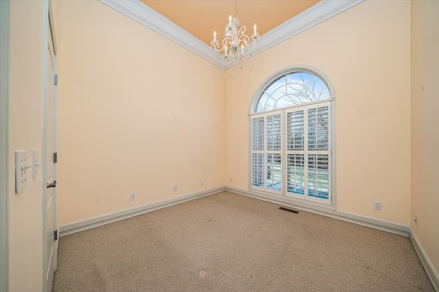 unfurnished room featuring a chandelier, light carpet, crown molding, and baseboards