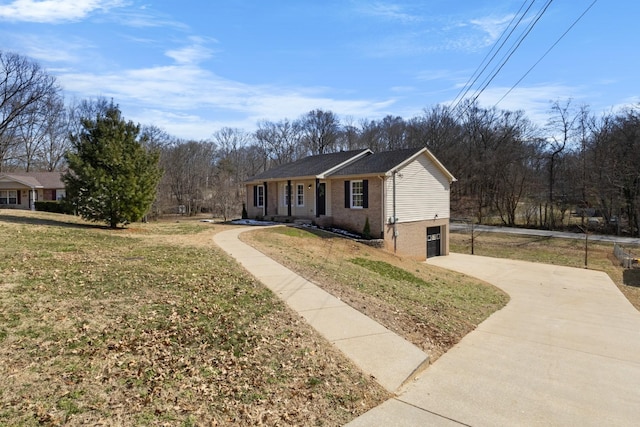 ranch-style house featuring a garage, a front lawn, concrete driveway, and brick siding