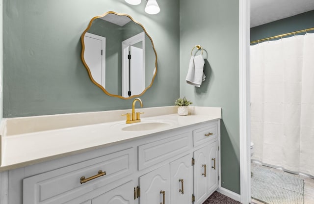 full bathroom with vanity and baseboards