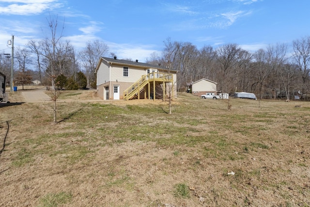 view of yard with stairs and a deck