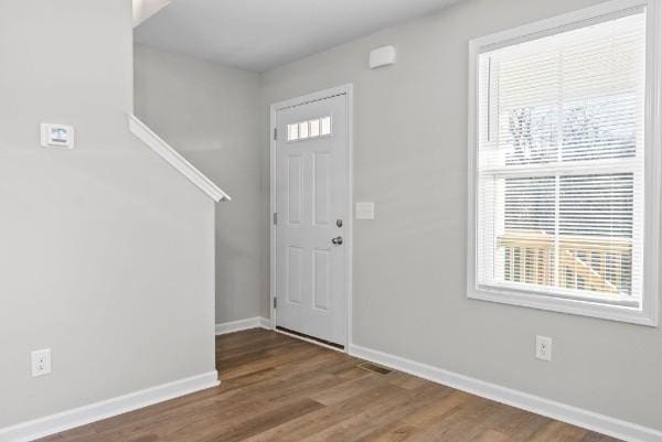 entrance foyer with wood finished floors, visible vents, and baseboards