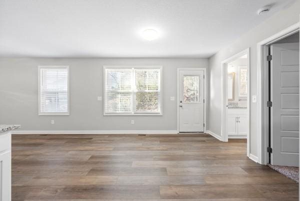 entrance foyer featuring light wood finished floors and baseboards