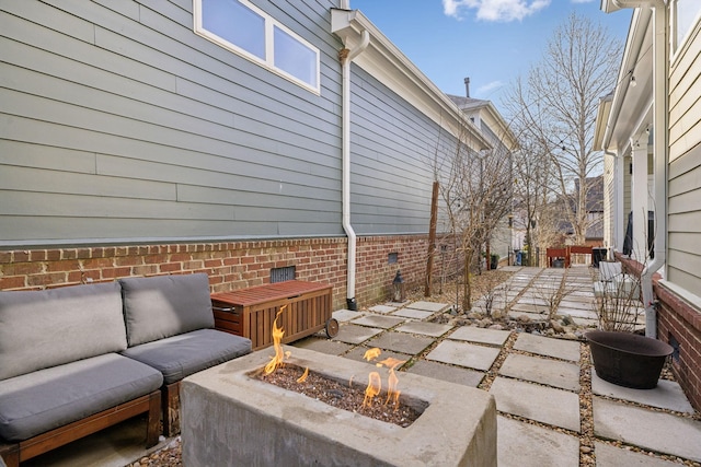 view of patio / terrace featuring an outdoor living space with a fire pit