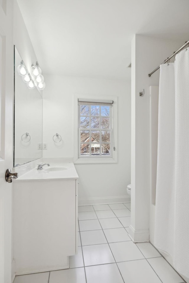 full bath with tile patterned flooring, baseboards, vanity, and toilet