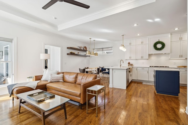 living area featuring ornamental molding, recessed lighting, ceiling fan, and wood finished floors