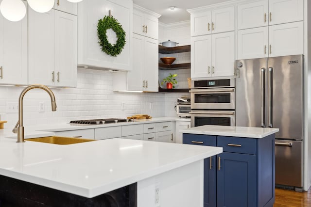 kitchen featuring stainless steel appliances, white cabinetry, light countertops, a center island, and open shelves