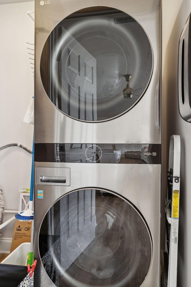 laundry area with stacked washer and clothes dryer and laundry area