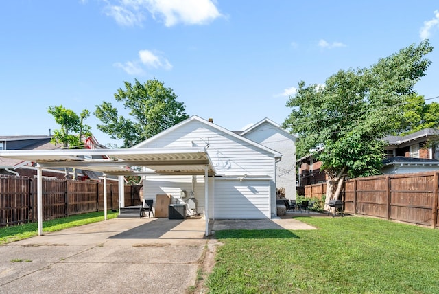 view of front of house with a detached carport, fence, driveway, and a front lawn