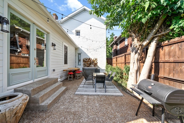 view of patio / terrace with entry steps, outdoor dining area, fence, and grilling area